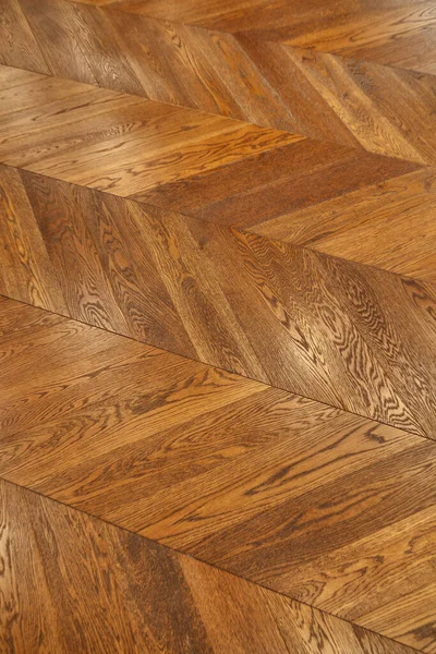 Fragment of brown wooden parquet floor.
