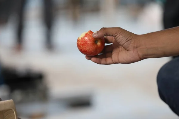 hand holding apple, closeup