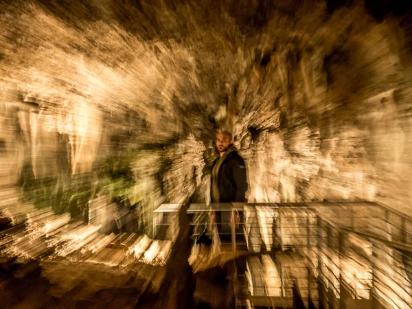 Man explores cave close-up view