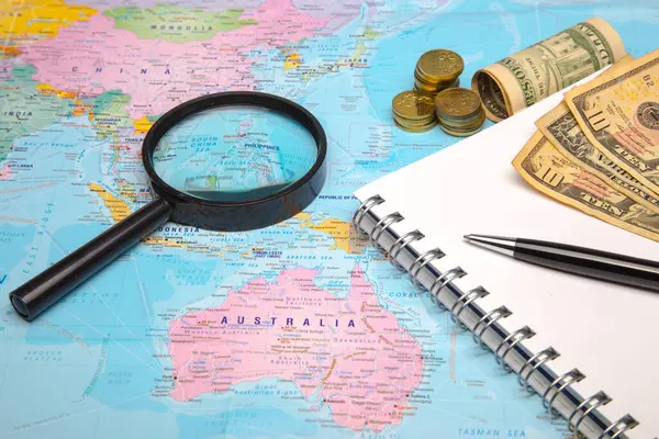 World Map Money Magnifying Glass Notepad Stock Picture