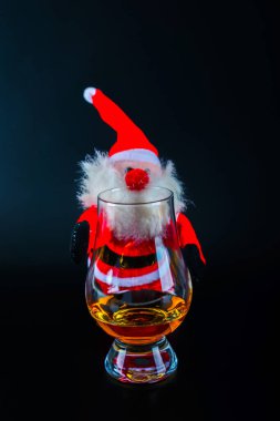 Plush Santa Claus with single malt whisky in  glass