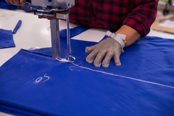 the process of sewing clothes in the factory.