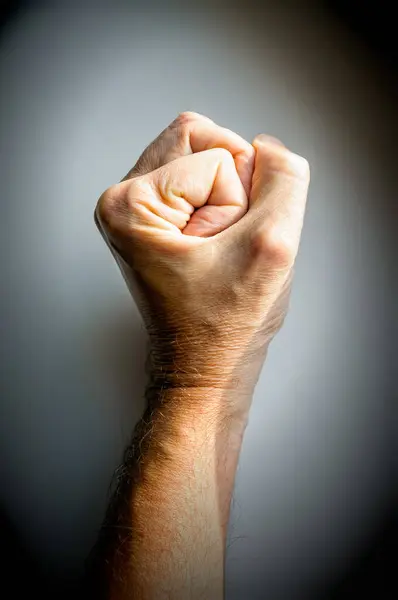 male fist clenched, fist in front