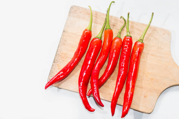 chili cayenne pepper on Chopping Block on white background