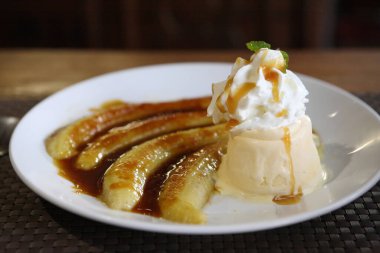 Dessert ice cream with sweet banana on wood background