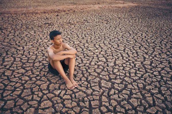 Sad Boy Sitting Cracked Earth — Stock Photo, Image