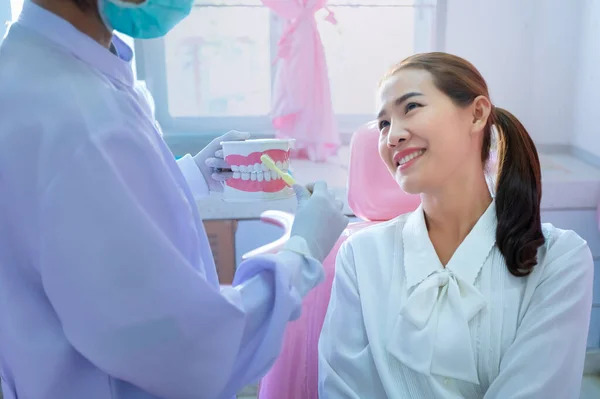 牙医正在演示如何为病人刷牙 — 图库照片