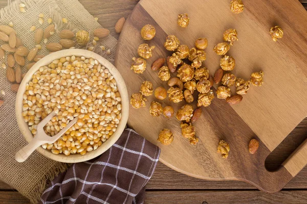 Corn Kernels Wooden Plates Popcorn Caramel Almonds — Stok fotoğraf