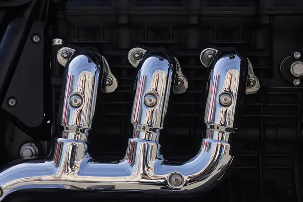Chrome motorcycle exhaust system near the engine