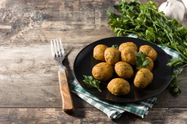 Traditional cod fritters decorated with garlic and parsley 