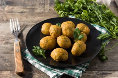 Traditional cod fritters decorated with garlic and parsley 