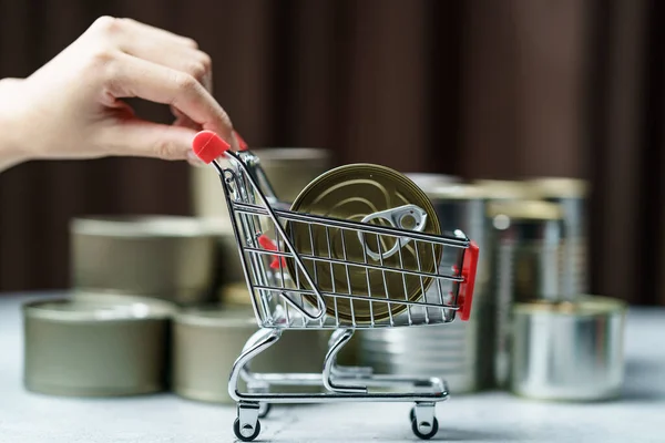 Canned food in shopping cart toy with Hand , group of Aluminium