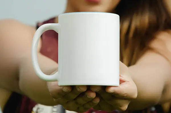 Blank cup in the hands