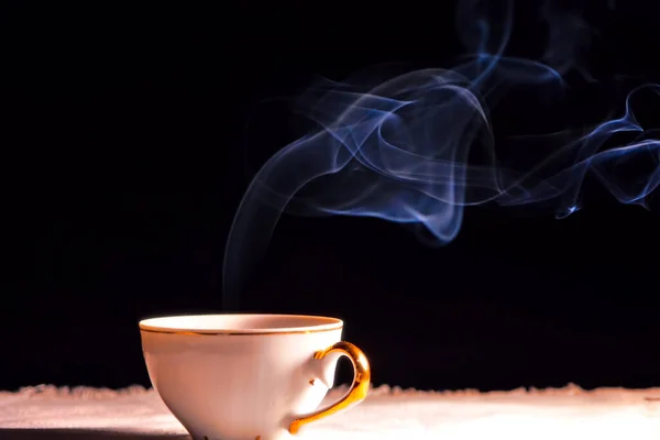 steaming cup of hot tea on background, close up