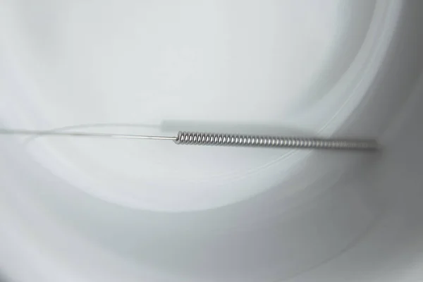 Acupuncture needle on background, close up