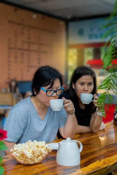 Best friends asian women drinking in coffee shop