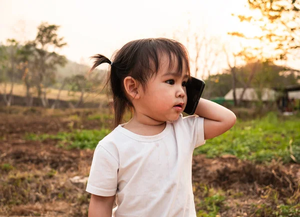 Азиатская Маленькая Девочка Играет Роль Разговаривая Телефону Матерью Саду Фоне — стоковое фото