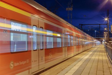 Modern train moving by railway station