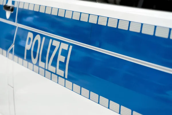Aufschrift Polizei Weißer Leuchtfarbe Auf Blauem Hintergrund Der Seite Eines — Stockfoto