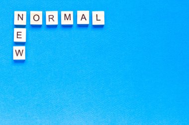 Tahta alfabe küpüyle ilgili yeni bir Normallik kelimesi. Yeni normal konsept. Üst görünüm, düz görünüm
