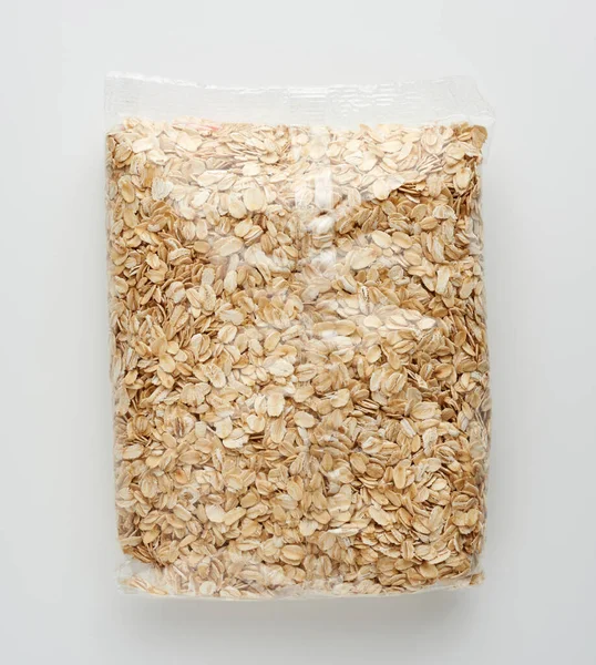 oatmeal in transparent plastic packaging on a white background