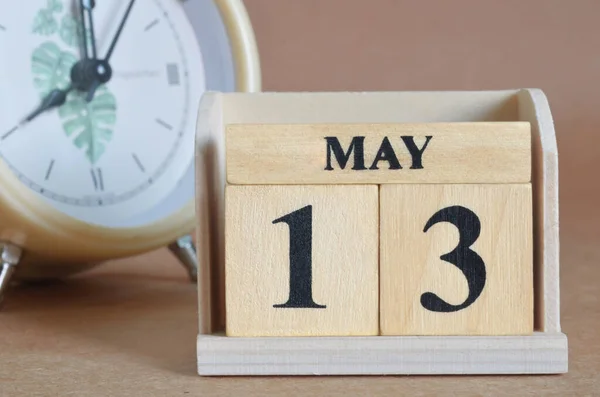 stock image white clock and wooden calendar with date May, 13