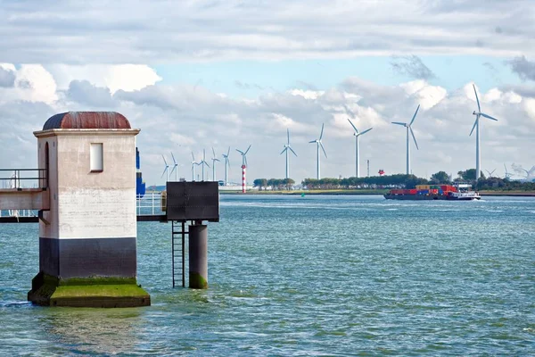 Large cargo ship and windmills by the sea in the Netherlands