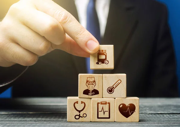 Man Builds Block Pyramid Medical Icons Symbols Healthcare Medical Insurance — Stock Fotó