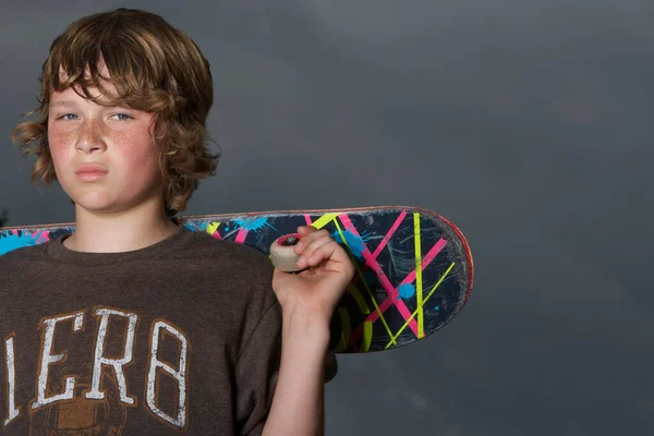 Teenage Boy Holding Skateboard Outdoors Portrait Close — Stock fotografie