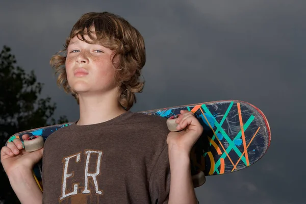 Teenage Boy Holding Skateboard Outdoors Portrait Close — Stock fotografie