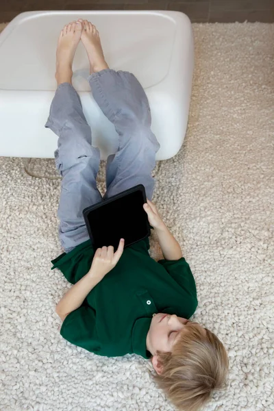 Young Boy Lying Rug Tablet — Stock Photo, Image