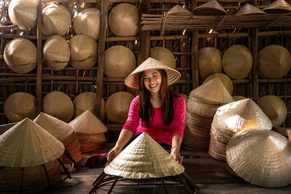 Asian traveler female craftsman making the traditional Vietnam