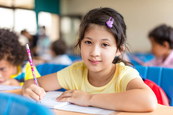 beautiful asian little girl  studying in the classroom.