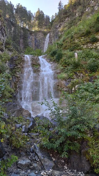 Scenic waterfall on rocks, Dolomites, Italy.