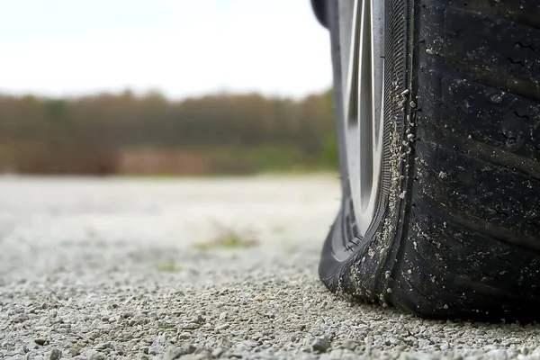 stock image Close-up of Flat rear tire on car. The right rear broken weel. Damaged rear wheels on parking place.