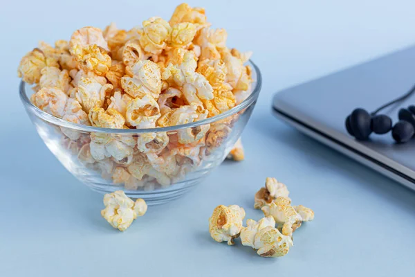 Przezroczysta Miska Popcornu Niebieskiej Powierzchni Obok Laptopa Słuchawek Rodziny Oglądające — Zdjęcie stockowe