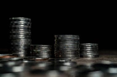 Stack of silver coins on dark background
