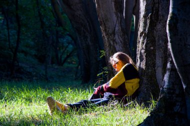 Woman in the botanic garden and park, trees and casual young girl portrait