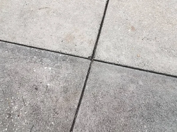 grey cement or sidewalk tiles with lines