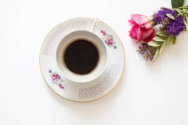 Coffee and flowers on white background