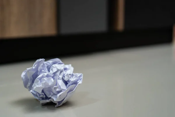 Crumpled balls of white paper on the floor