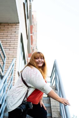 Plus size woman photographer outdoors