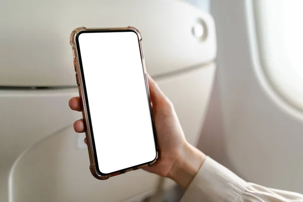 Woman on board of an airplane with white screen mobile mockup