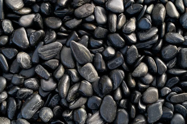 Zářící Hladké Černé Plážové Kameny Pozadí — Stock fotografie