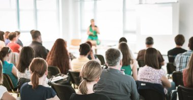 Speaker giving a talk in conference hall at business meeting event. Rear view of unrecognizable people in audience at the conference hall. clipart