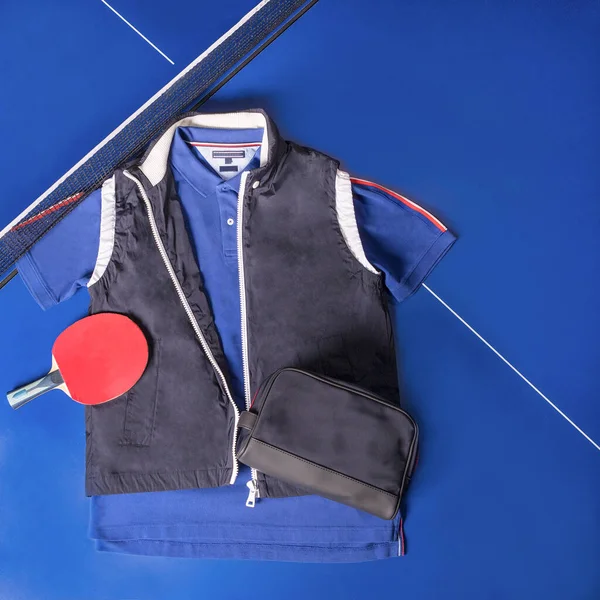 Blue tennis wear, shirt and jacket top view