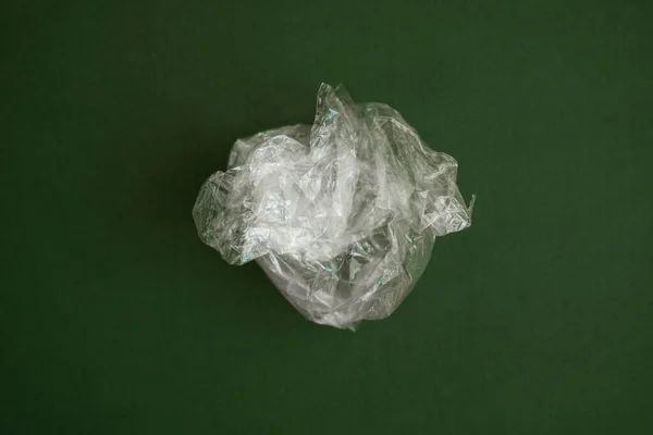 Crumpled Plastic Polyethylene Bag Green Background Contamination Planet Clear Plastic — Stock Photo, Image