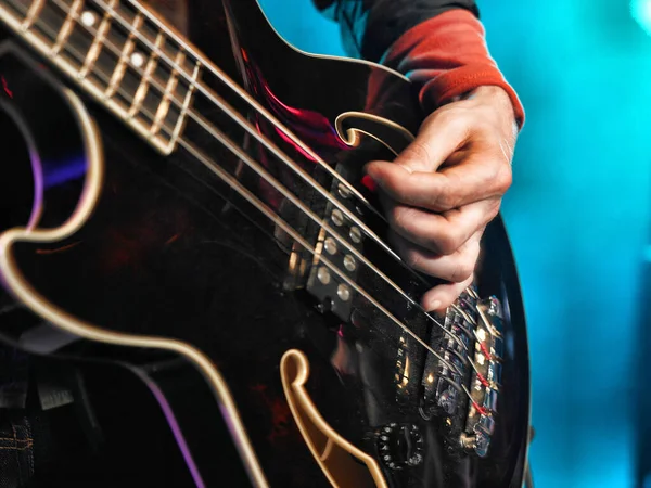 a closeup shot of a guitar on blue background