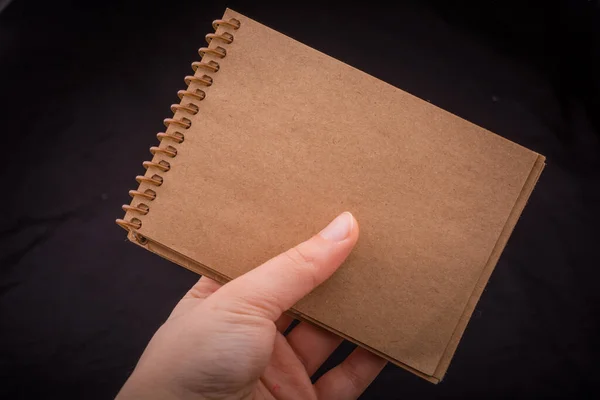 Notebook Hand Black Color Background — Zdjęcie stockowe
