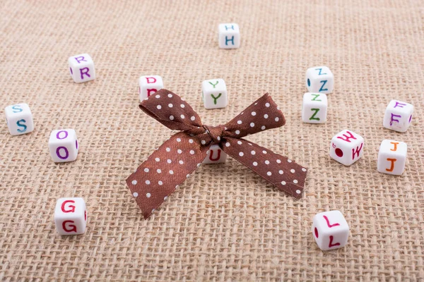 Ribbon Scattered Dice Sized Alphabet Cubes Textured Surface — Stock Photo, Image